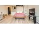 Living area with hidden murphy bed, light wood flooring, and wall-mounted television at 65 N Clarkson St # 604, Denver, CO 80218