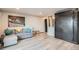 Cozy living room with light wood floors, gray sofa, and Union Station wall art at 65 N Clarkson St # 604, Denver, CO 80218