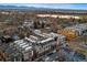 Stunning aerial view of modern townhomes near a picturesque lake and mountain range in a desirable neighborhood at 4469 Tennyson St # 15, Denver, CO 80212