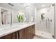 Modern bathroom with double sink vanity, marble tile, and glass-enclosed shower at 4469 Tennyson St # 15, Denver, CO 80212