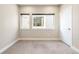 Empty bedroom featuring neutral tones, carpet, and a large window at 4469 Tennyson St # 15, Denver, CO 80212