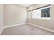 Empty bedroom featuring neutral tones, carpet, and a large window at 4469 Tennyson St # 15, Denver, CO 80212