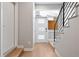 Inviting entryway with modern door, sleek staircase, and bright, minimalist design elements at 4469 Tennyson St # 15, Denver, CO 80212