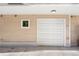 Attached garage with white door and small adjacent window providing natural light at 4469 Tennyson St # 15, Denver, CO 80212
