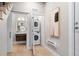 Hallway with a peek into the half bath and laundry, showcasing smart space-saving design at 4469 Tennyson St # 15, Denver, CO 80212