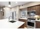 Modern kitchen design with stainless steel appliances, an island sink, and pendant lighting at 4469 Tennyson St # 15, Denver, CO 80212