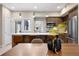 Stylish kitchen with stainless steel appliances, a quartz countertop island, and modern barstools at 4469 Tennyson St # 15, Denver, CO 80212