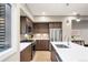 Well-equipped kitchen with stainless steel appliances, white countertops, and modern dark wood cabinetry at 4469 Tennyson St # 15, Denver, CO 80212