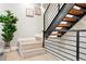 Modern staircase features black metal railings and wooden steps, complemented by stylish decor at 4469 Tennyson St # 15, Denver, CO 80212