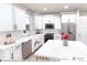 Bright kitchen features white cabinets, stainless steel appliances, and white marble countertops at 1577 W 166Th Ave, Broomfield, CO 80023