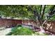 Landscaped backyard with mature tree offering shade at 13673 Cook St, Thornton, CO 80602