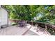 Backyard deck with a table and chairs surrounded by lush trees at 13673 Cook St, Thornton, CO 80602