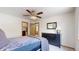 Bedroom featuring neutral decor, closet and bathroom entrances, and a ceiling fan at 13673 Cook St, Thornton, CO 80602