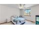 Bedroom with a ceiling fan, large window, and blue sea turtle themed bedding at 13673 Cook St, Thornton, CO 80602