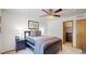 Bedroom with a ceiling fan, neutral walls, and a view into the walk-in closet at 13673 Cook St, Thornton, CO 80602