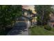 Inviting two-story home with lush landscaping, warm exterior lighting, and a brick facade for added charm and curb appeal at 13673 Cook St, Thornton, CO 80602