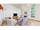 Airy living room with a fireplace, lots of natural light, and hardwood floors, making it the perfect space to relax and unwind at 13673 Cook St, Thornton, CO 80602