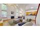 Bright living room featuring high ceilings, a fireplace, and an open floor plan, creating a spacious and inviting atmosphere at 13673 Cook St, Thornton, CO 80602