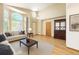 Spacious living room with high ceilings, large windows, hardwood floors, and modern decor at 13673 Cook St, Thornton, CO 80602