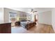 Serene main bedroom with hardwood floors, ample natural light, and a ceiling fan at 13673 Cook St, Thornton, CO 80602