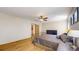 Bright main bedroom with hardwood floors, closet, ceiling fan and convenient access to the bathroom at 13673 Cook St, Thornton, CO 80602