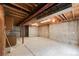 Unfinished basement featuring exposed ceilings and concrete walls at 205 Hawthorn St, Frederick, CO 80530