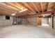 Unfinished basement featuring exposed beams and concrete floors at 205 Hawthorn St, Frederick, CO 80530