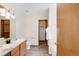 Well-lit bathroom featuring a single sink vanity, toilet, and access to the shower/tub at 205 Hawthorn St, Frederick, CO 80530