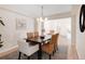 Formal dining room featuring wood table, seating for six, and access to living area at 205 Hawthorn St, Frederick, CO 80530