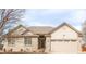 Charming single-story home with a well-maintained lawn and attached two-car garage at 205 Hawthorn St, Frederick, CO 80530