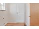 Hallway with a white exterior door, light walls, and wood look floor at 205 Hawthorn St, Frederick, CO 80530
