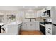 Updated kitchen featuring stainless steel appliances, stone countertops, and modern cabinetry at 205 Hawthorn St, Frederick, CO 80530