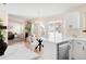 View of kitchen island, stainless steel dishwasher, and living room with fireplace beyond at 205 Hawthorn St, Frederick, CO 80530