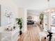 View of open living room, dining nook, and entry featuring light hardwood floors at 205 Hawthorn St, Frederick, CO 80530