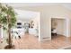 Bright living room featuring hardwood floors, a white kitchen, and an open floor plan at 205 Hawthorn St, Frederick, CO 80530