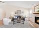 Comfortable living room featuring a fireplace, plush seating, and bright natural light at 205 Hawthorn St, Frederick, CO 80530