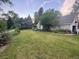 Expansive backyard with lush green lawn and mature trees offering shade and privacy at 6375 E 6Th Avenue Pkwy, Denver, CO 80220