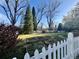 Backyard view featuring garden beds and a white picket fence at 6375 E 6Th Avenue Pkwy, Denver, CO 80220