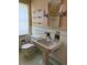 Classic bathroom featuring a pedestal sink, tiled walls, and open shelving at 6375 E 6Th Avenue Pkwy, Denver, CO 80220
