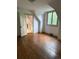 Bright bedroom with hardwood floors, large window, and connecting door to another room at 6375 E 6Th Avenue Pkwy, Denver, CO 80220