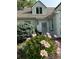 Inviting exterior with brick and blooming pink peonies at 6375 E 6Th Avenue Pkwy, Denver, CO 80220