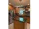 The kitchen has wooden cabinets, stainless appliances, a kitchen island, and pendant lighting at 6375 E 6Th Avenue Pkwy, Denver, CO 80220