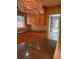 The kitchen has granite counters, wooden cabinets, tiled backsplash, and a modern pendant light at 6375 E 6Th Avenue Pkwy, Denver, CO 80220