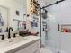 Bright bathroom featuring white subway tile shower with sliding glass door and a modern vanity with marble countertop at 1472 Yates St, Denver, CO 80204