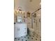Stylish bathroom featuring a glass shower, patterned tile floor, vanity and modern lighting at 1472 Yates St, Denver, CO 80204