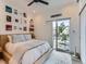 Cozy bedroom featuring a comfortable bed, natural light, and access to an outdoor balcony at 1472 Yates St, Denver, CO 80204