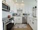 Well-appointed kitchen with stainless steel appliances, white cabinets, and light countertops at 1472 Yates St, Denver, CO 80204