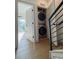 Conveniently located laundry area with stacked washer and dryer, near entryway at 1472 Yates St, Denver, CO 80204