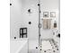 Modern shower featuring sleek glass doors, white subway tile, and matte black plumbing fixtures at 1472 Yates St, Denver, CO 80204