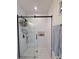 Modern shower with sleek glass doors, white subway tile, and convenient built-in shelving at 1472 Yates St, Denver, CO 80204